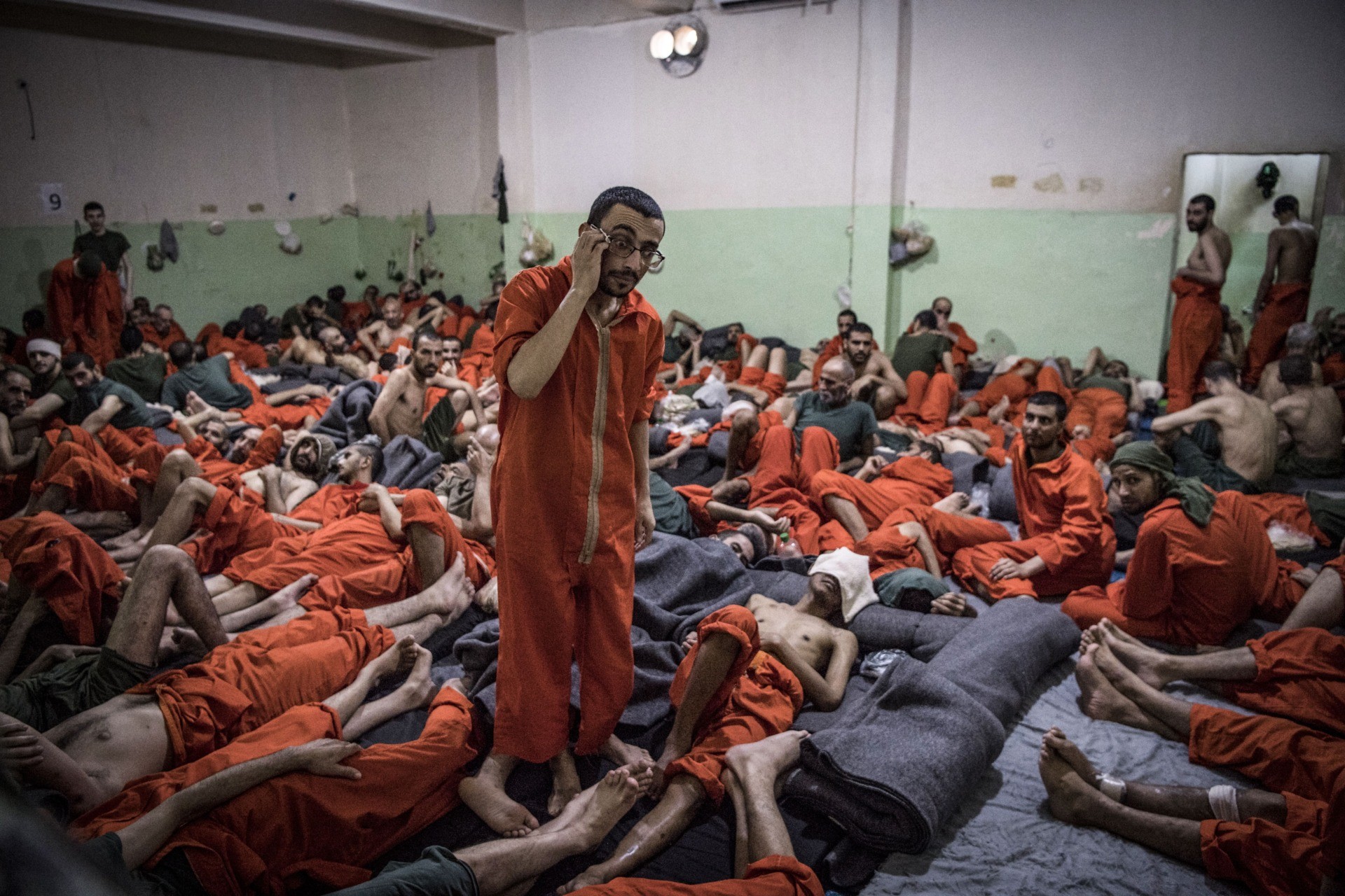 TOPSHOT - Men, suspected of being affiliated with the Islamic State (IS) group, gather in a prison cell in the northeastern Syrian city of Hasakeh on October 26, 2019. - Kurdish sources say around 12,000 IS fighters including Syrians, Iraqis as well as foreigners from 54 countries are being held in Kurdish-run prisons in northern Syria. (Photo by FADEL SENNA / AFP) (Photo by FADEL SENNA/AFP via Getty Images)