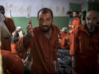 TOPSHOT - Men, suspected of being affiliated with the Islamic State (IS) group, gather in a prison cell in the northeastern Syrian city of Hasakeh on October 26, 2019. - Kurdish sources say around 12,000 IS fighters including Syrians, Iraqis as well as foreigners from 54 countries are being held …