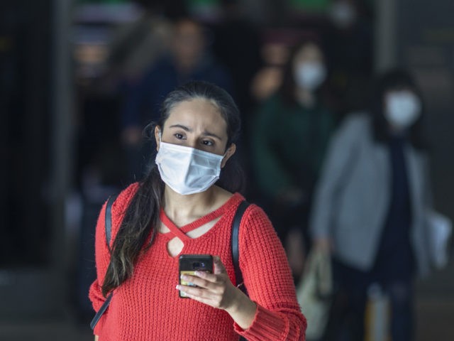 LOS ANGELES, CA - FEBRUARY 02: Travelers arrive to LAX Tom Bradley International Terminal wearing medical masks for protection against the novel coronavirus outbreak on February 2, 2020 in Los Angeles, California. The United States has declared a public health emergency and will implement strict travel restrictions later today. Foreign …