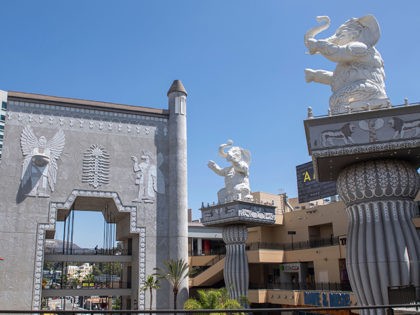 Elephant topped columns and an arch with Babylonian images framing the Hollywood sign in the distance are seen inside the Hollywood & Highland shopping center on August 7 2020, in Hollywood, California. - The center is getting a makeover and will lose the elephant and the arch, references to DW …