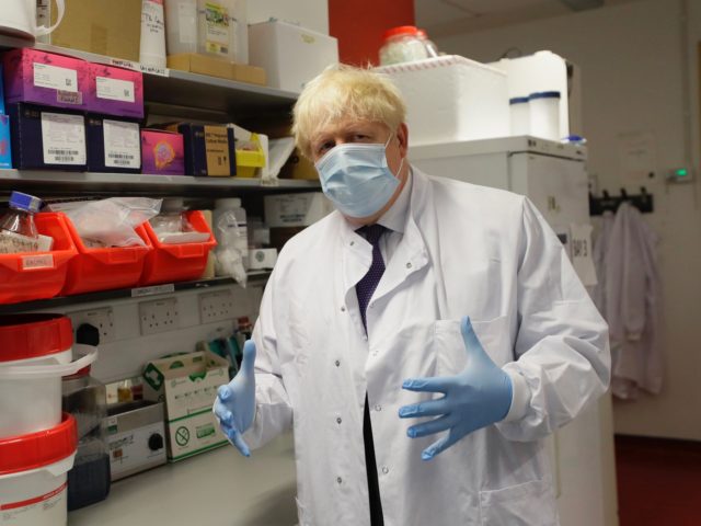 OXFORD, ENGLAND - SEPTEMBER 18: Britain's Prime Minister, Boris Johnson gestures during a visit to the Jenner Institute on September 18, 2020 in Oxford, England. The Prime Minister toured the laboratory and met scientists who are leading the COVID-19 vaccine research. (Photo by Kirsty Wigglesworth - WPA Pool/Getty Images)