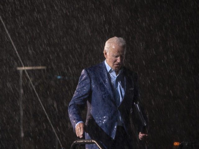 TAMPA, FL - OCTOBER 29: Democratic presidential nominee Joe Biden leaves the stage during a downpour after concluding his remarks at a drive-in campaign rally at the Florida State Fairgrounds on October 29, 2020 in Tampa, Florida. Biden is campaigning in Florida on Thursday, with drive-in rallies in Tampa and …