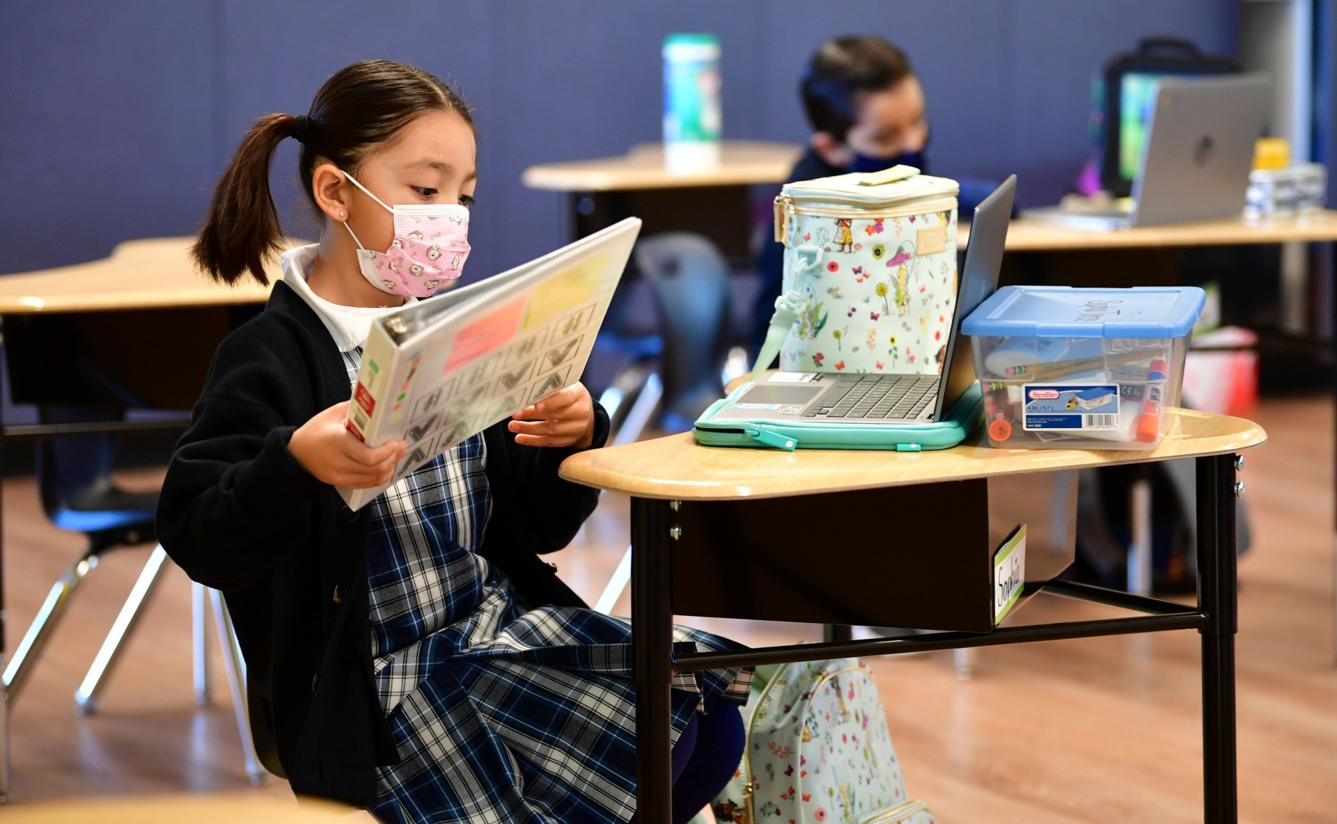 First grade students prepare for class at St. Joseph Catholic School in La Puente, California on November 16, 2020, where pre-kindergarten to Second Grade students in need of special services returned to the classroom today for in-person instruction. - The campus is the second Catholic school in Los Angeles County to receive a waiver approval to reopen as the coronavirus pandemic rages on. The US surpassed 11 million coronavirus cases Sunday, adding one million new cases in less than a week, according to a tally by Johns Hopkins University. (Photo by Frederic J. BROWN / AFP) (Photo by FREDERIC J. BROWN/AFP via Getty Images)