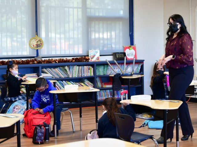 First grade instructor Laura Sanchez speaks to her returning students at St. Joseph Catholic School in La Puente, California on November 16, 2020, where pre-kindergarten to Second Grade students in need of special services returned to the classroom today for in-person instruction. - The campus is the second Catholic school …