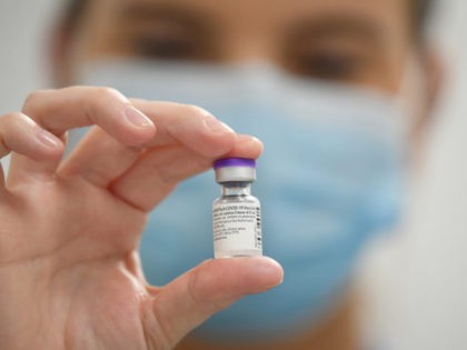 CARDIFF, WALES - DECEMBER 08: A member of staff poses with a phial of Pfizer-BioNTech Covi