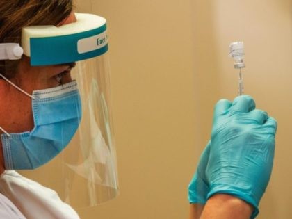 Pharmacist Alyssa Short prepares a syringe with the vaccine at Backus Hospital where 211 d