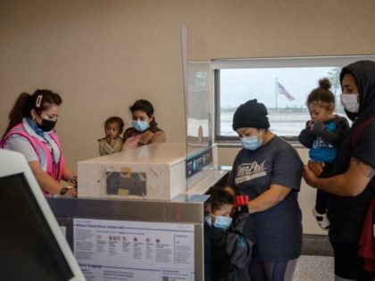 Ivania (29, C) from Honduras checks-in for a flight with her family but without her 11-year-old son Jhowell, after being released from a Border Patrol holding center for illegal immigrants, at McAllen airport, Texas, on March 30, 2021. - Jhowell first arrived to the US with his parents and two …