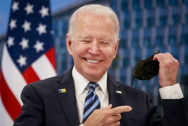 US President Joe Biden takes off his face mask he meets with NATO Secretary General during