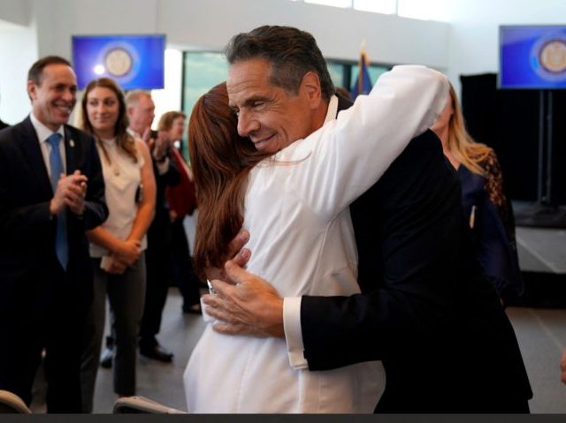 New York Governor Andrew Cuomo hugs Northwell Health Director of Patient Services Sandra L
