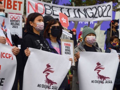 Activists including members of the local Hong Kong, Tibetan and Uyghur communities hold up