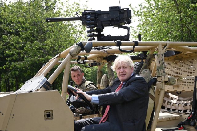 Britain's Prime Minister Boris Johnson poses in an armoured vehicle of the new Ranger Regi