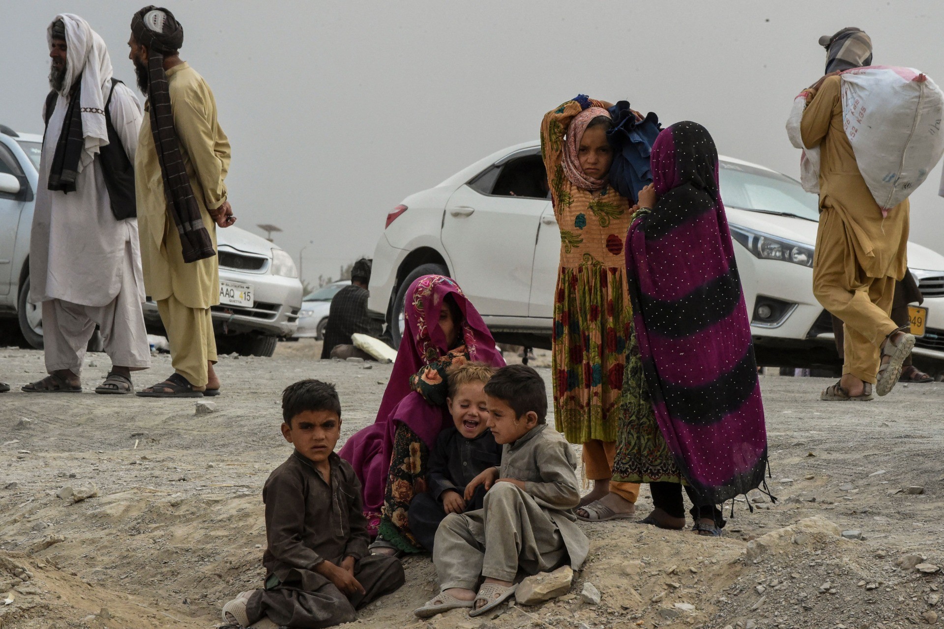 Stranded people wait for the reopening of border crossing point in the Pakistan's border town of Chaman on July 16, 2021, following clashes between Afghan forces and Taliban fighters in Spin Boldak to retake the key border crossing with Pakistan. (Photo by Banaras KHAN / AFP) (Photo by BANARAS KHAN/AFP via Getty Images)