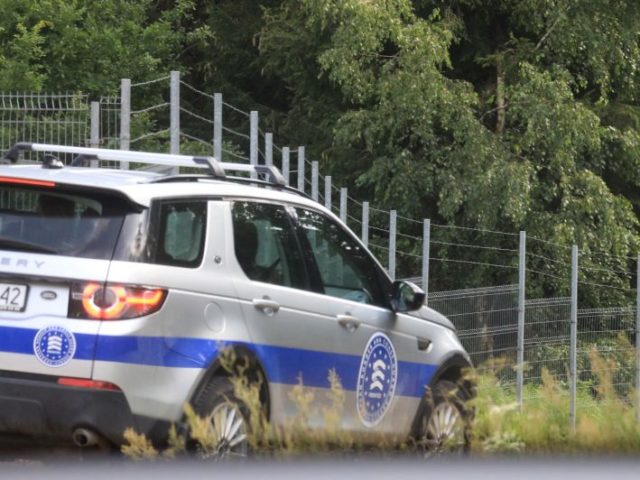 A car of the European Border and Coast Guard Agency (FRONTEX) is seen through a carglas as they patrol the border separating Lithuania (R) and Belarus, near Kapciamiestis, Lithuania, on July 18, 2021. - Lithuania has seen more than 2,000 arrivals since the start of the year across the border …