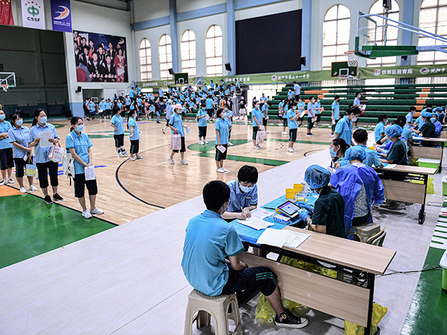 Student queue to receive the Sinopharm Covid-19 vaccine at a high school in Shenyang in Ch