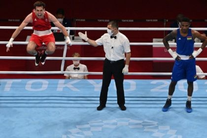 TOPSHOT - Ireland's Aidan Walsh (red) celebrates after winning against Mauritius' Merven Clair after their men's welter (63-69kg) quarter-final boxing match during the Tokyo 2020 Olympic Games at the Kokugikan Arena in Tokyo on July 30, 2021. (Photo by Luis ROBAYO / AFP) (Photo by LUIS ROBAYO/AFP via Getty Images)