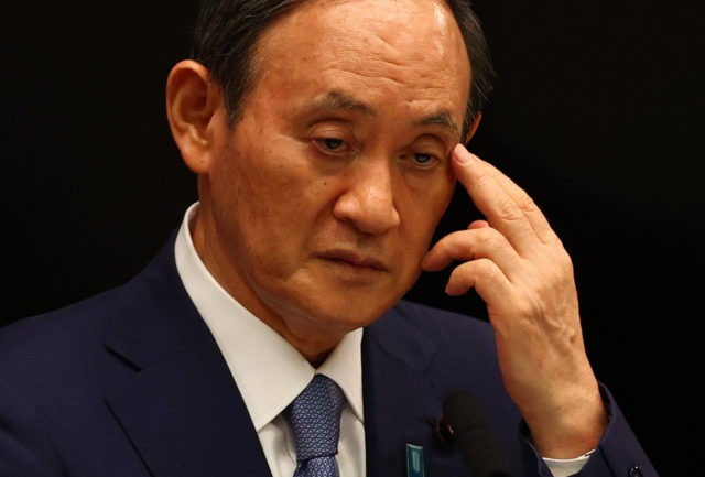 Japan's Prime Minister Yoshihide Suga attends a news conference on Japan's response to the