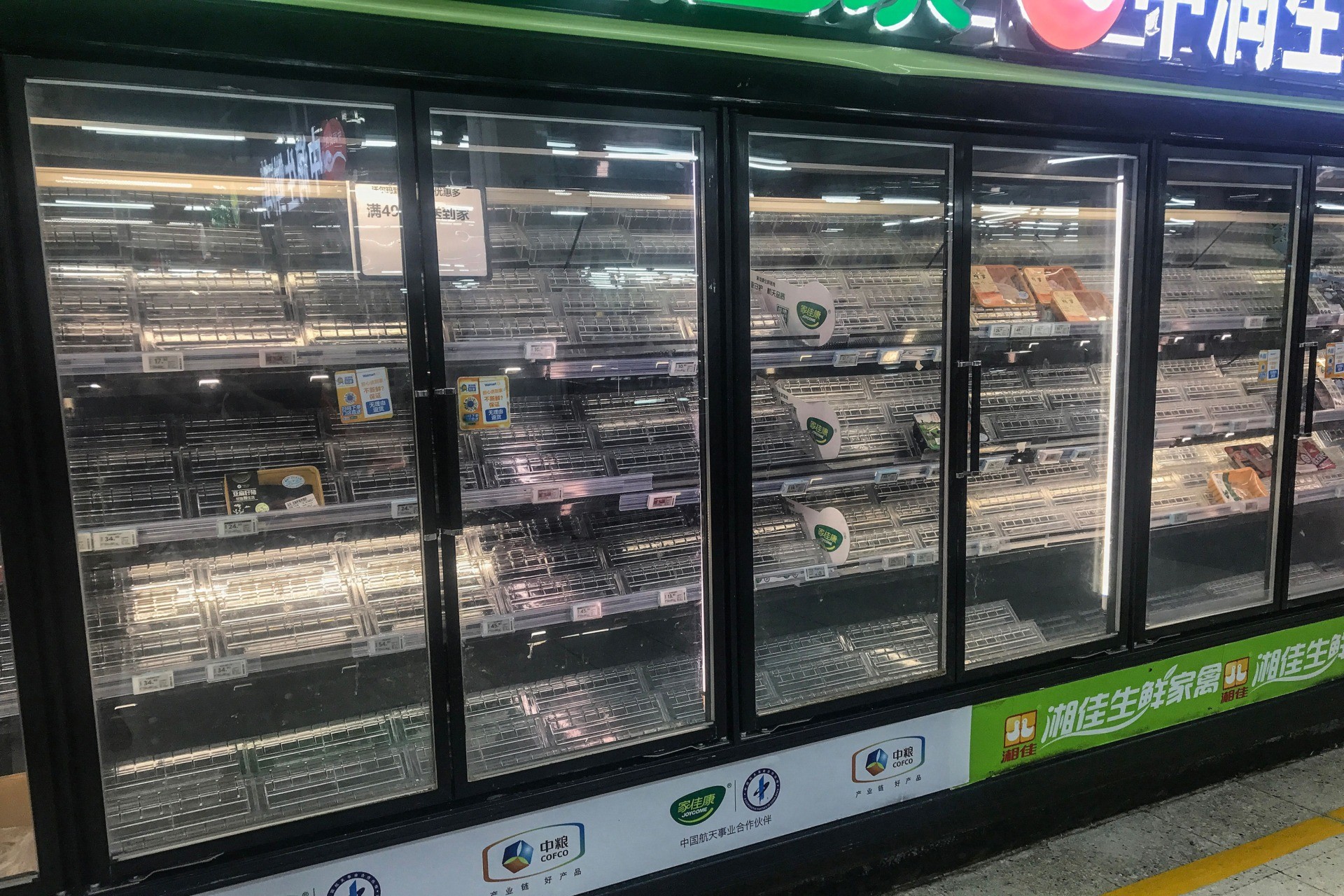 This photo taken on August 2, 2021 shows empty shelves as people buy items at a supermarket in Wuhan, in China's central Hubei province, as authorities said they would test its entire population for Covid-19 after the central Chinese city where the coronavirus emerged reported its first local infections in more than a year. - China OUT (Photo by STR / AFP) / China OUT (Photo by STR/AFP via Getty Images)