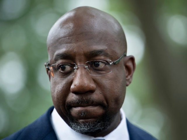 Sen. Raphael Warnock(R) (D-GA) speaks to people rallying for voters' rights on Capitol Hil