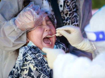 This photo taken on August 5, 2021 shows a child receiving a nucleic acid test for the Cov