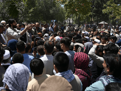 Internally displaced Afghan men, who fled from Kunduz province due to battles between Taliban and Afghan security, gather as they register to recive food at the Shahr-e-Naw Park in Kabul on August 10, 2021. (Photo by WAKIL KOHSAR / AFP) (Photo by WAKIL KOHSAR/AFP via Getty Images)