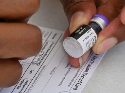 A healthcare worker fills out a Covid-19 vaccination card at a community healthcare event in a predominately Latino neighborhood in Los Angeles, California, August 11, 2021. - All teachers in California will have to be vaccinated against Covid-19 or submit to weekly virus tests, Governor Gavin Newsom announced on August …