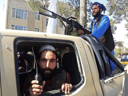 In this picture taken on August 13, 2021, Taliban fighters are pictured in a vehicle along