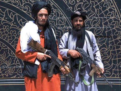 Taliban fighters stand guard in front of the provincial governor's office in Herat on August 14, 2021. (Photo by - / AFP) (Photo by -/AFP via Getty Images)
