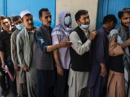 Afghans wait in long lines for hours at the passport office as many are desperate to have their travel documents ready to go on August 14, 2021 in Kabul, Afghanistan. (Paula Bronstein /Getty Images)