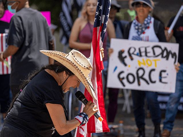 A woman holds an American flag and prays "in tongues," or in an unknown language