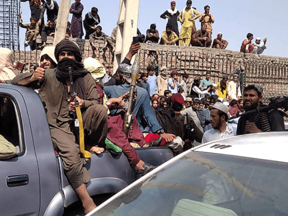 Taliban fighters sit on a vehicle along the street in Jalalabad province on August 15, 202