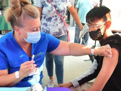 Roberto Ortega, 16, awaits the Pfizer Covid-19 vaccine administered by Registered Nurse Am