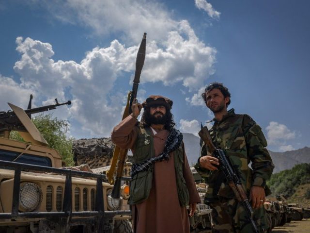 TOPSHOT - Afghan armed men supporting the Afghan security forces against the Taliban stand