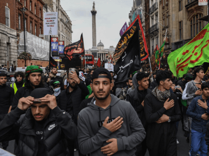 Shiite Muslims take part in the annual 'Ashura Day' march in central London on August 19, 2021. - Shiite Muslims, on the tenth day of the Islamic month of Muharram which marks the peak of Ashura, commemorate the martyrdom of Prophet Mohammad's grandson Imam Hussein, who was killed in the …