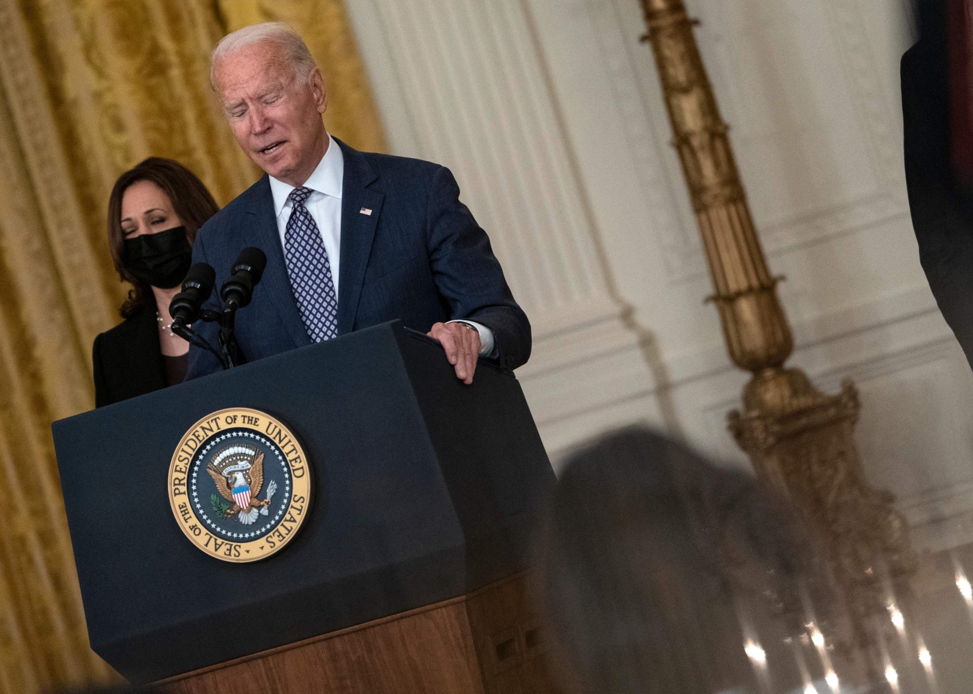 US President Joe Biden, with Vice President Kamala Harris, responds to questions about the ongoing US military evacuations of US citizens and vulnerable Afghans, in the East Room of the White House in Washington, DC, on August 20, 2021. - Biden said Friday he has not seen America's allies question US credibility over the conduct of its withdrawal from Afghanistan as the Taliban took over the country. (Photo by ANDREW CABALLERO-REYNOLDS / AFP) (Photo by ANDREW CABALLERO-REYNOLDS/AFP via Getty Images)