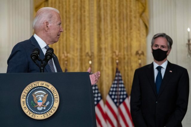 US President Joe Biden, with Secretary of State Antony Blinken (R), speaks about the ongoi