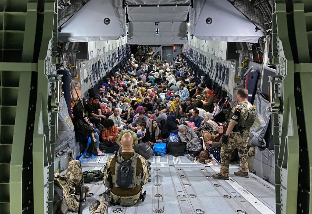 TASHKENT, UZBEKISTAN – AUGUST 22: In this handout image provided by the Bundeswehr, evacuees from Kabul sit inside a military aircraft as they arrive at Tashkent Airport on August 22, 2021 in Tashkent, Uzbekistan. German Chancellor Merkel said Germany must urgently evacuate up to 10,000 people from Afghanistan for which it is responsible. (Photo by Handout/Bundeswehr via Getty Images)