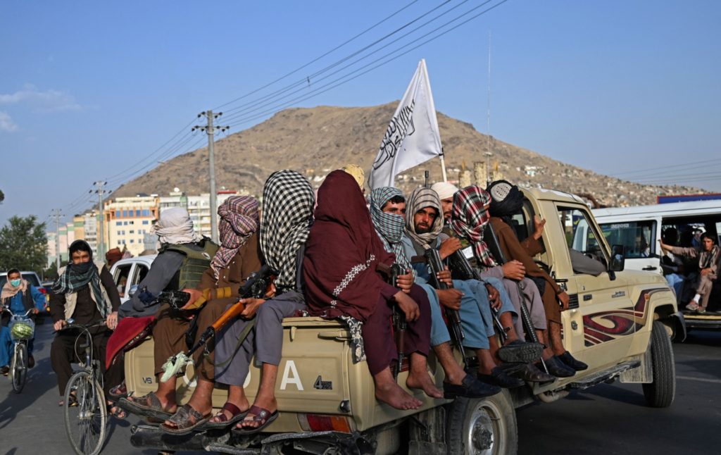 TOPSHOT - Taliban fighters in a vehicle patrol the streets of Kabul on August 23, 2021 as in the capital, the Taliban have enforced some sense of calm in a city long marred by violent crime, with their armed forces patrolling the streets and manning checkpoints. (Photo by Wakil KOHSAR / AFP) (Photo by WAKIL KOHSAR/AFP via Getty Images)