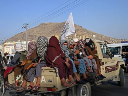 TOPSHOT - Taliban fighters in a vehicle patrol the streets of Kabul on August 23, 2021 as in the capital, the Taliban have enforced some sense of calm in a city long marred by violent crime, with their armed forces patrolling the streets and manning checkpoints. (Photo by Wakil KOHSAR …