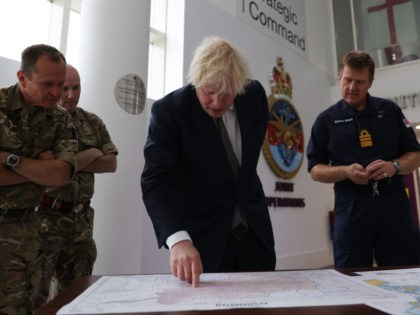 EASTBURY, UNITED KINGDOM - AUGUST 26: Britain's Prime Minister Boris Johnson (C) stands with Vice Admiral Ben Key (R) as he looks at a map of the Afghanistan region during a visit to Northwood Headquarters, the British Armed Forces Permanent Joint Headquarters on August 26, 2021, in Eastbury, northwest of …