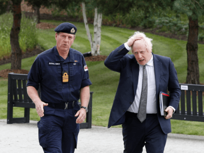 EASTBURY, UNITED KINGDOM - AUGUST 26: Britain's Prime Minister Boris Johnson (R) walks with Vice Admiral Ben Key (L) as he arrives for a visit at Northwood Headquarters, the British Armed Forces Permanent Joint Headquarters on August 26, 2021, in Eastbury, northwest of London, England. The Prime Minister visited Northwood …