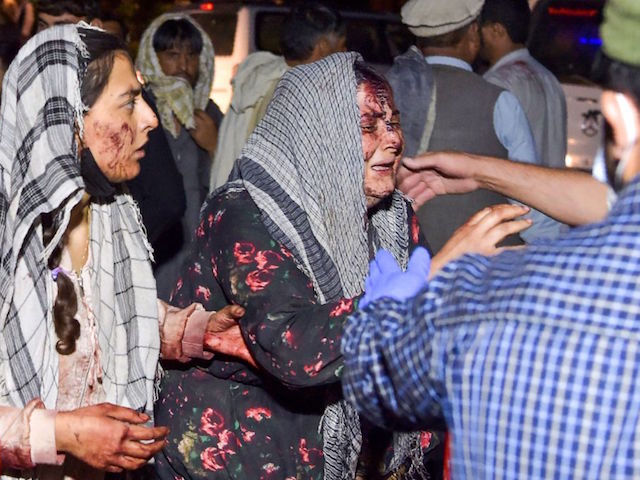 EDITORS NOTE: Graphic content / TOPSHOT - Wounded women arrive at a hospital for treatment after two blasts, which killed at least five and wounded a dozen, outside the airport in Kabul on August 26, 2021. (Photo by Wakil KOHSAR / AFP) (Photo by WAKIL KOHSAR/AFP via Getty Images)