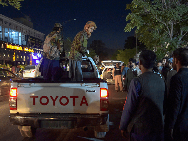EDITORS NOTE: Graphic content / Taliban fighters stand on a pickup truck outside a hospita