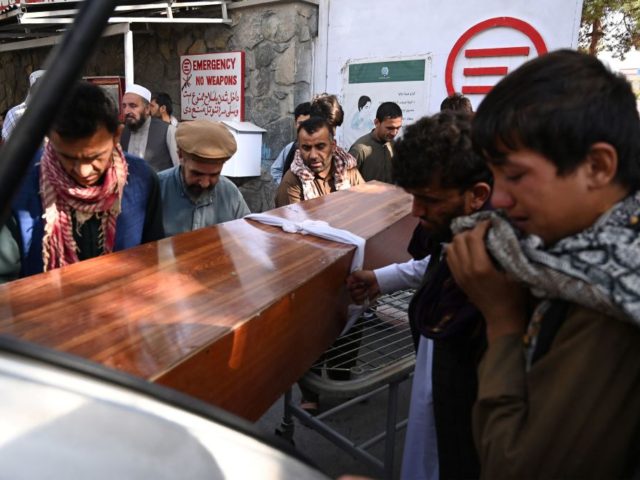 Relatives load in a car the coffin of a victim of the August 26 twin suicide bombs, which killed scores of people including 13 US troops outside Kabul airport, at a hospital run by the Italian NGO Emergency in Kabul on August 27, 2021. (Photo by Aamir QURESHI / AFP) …