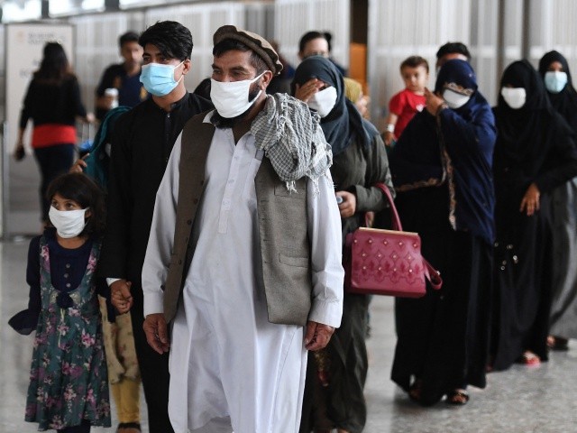 Afghan refugees arrive at Dulles International Airport on August 27, 2021 in Dulles, Virginia, after being evacuated from Kabul following the Taliban takeover of Afghanistan. (Olivier Douliery/AFP via Getty Images)