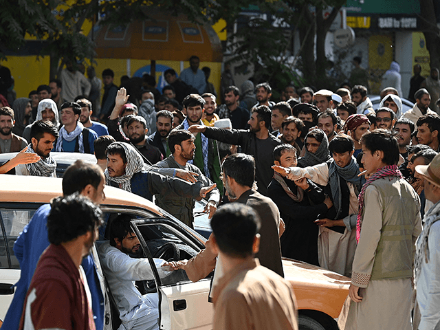 Bank account holders gather outside a closed bank building in Kabul on August 28, 2021, fo