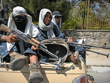 Taliban fighters patrol a street in Kabul on August 29, 2021, as suicide bomb threats hung