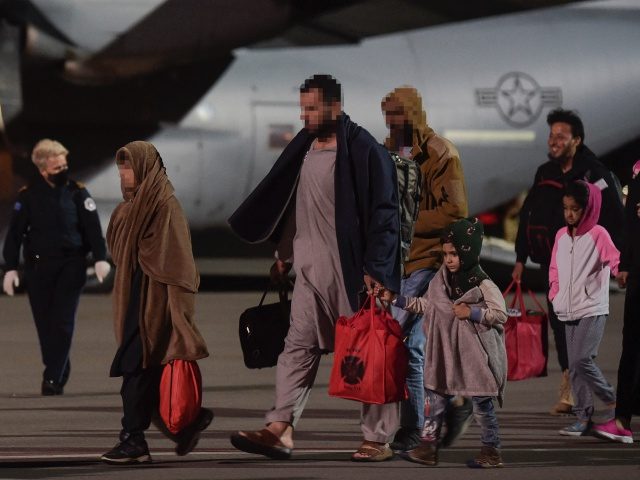 Afghan refugees, fleeing the Afghan capital Kabul, exit an US air force plane upon their a