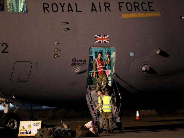 British Armed Forces personnel disembark a British Royal Air Force Boeing C-17A Globemaste