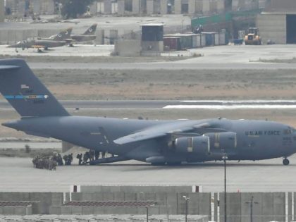 US soldiers board an US Air Force aircraft at the airport in Kabul on August 30, 2021. - R