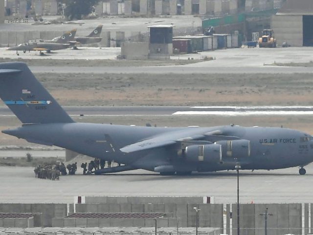 US soldiers board an US Air Force aircraft at the airport in Kabul on August 30, 2021. - R